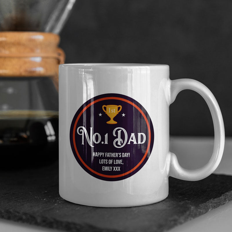 A personalised Father's Day mug which is made from white ceramic and has a black and red design printed on it featuring the words 
