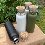 4 personalised metal water bottles with "Number 1 Dad" engraved on the lid. The bottles are all different colours, green, black, white and silver. 