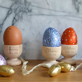 Three personalised egg cups with the words "Dippy Egg" engraved on the font along with a name. 