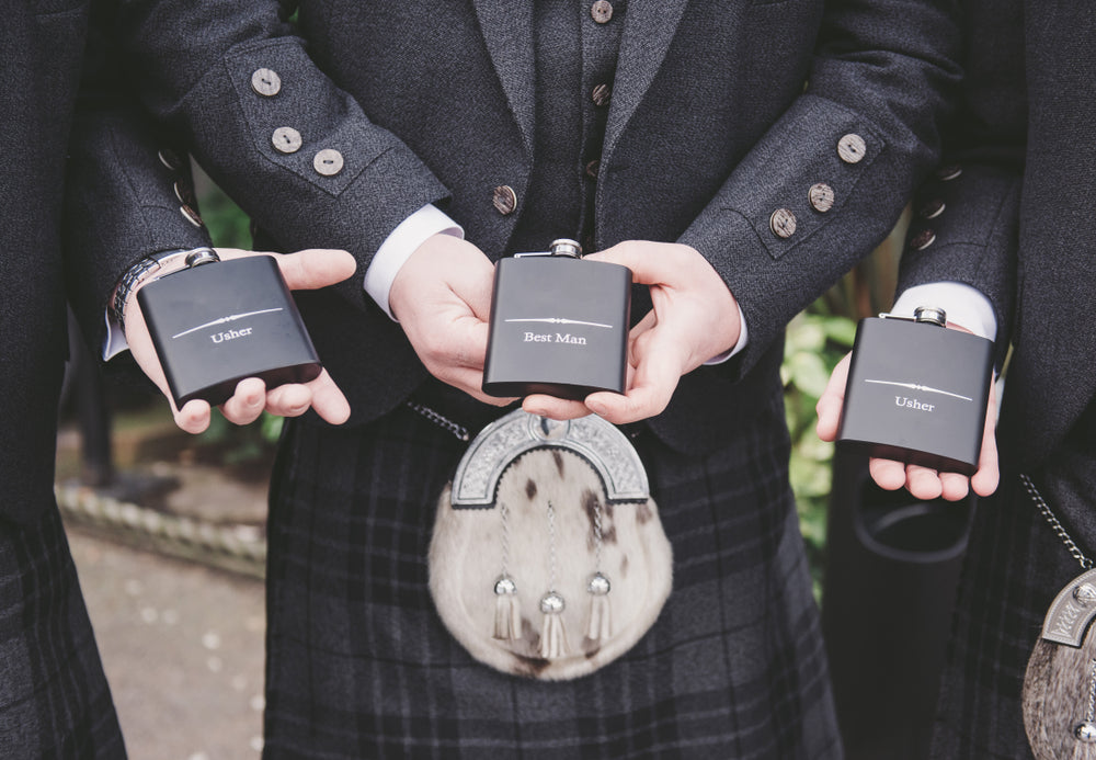 Groom and best men with hip flasks