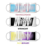 Three 10oz mugs laid out vertically, all showing the full wrap of the personalised LGBTQ+ flags. The first mug shows the Transgender flag with the colours: Baby Blue, Light Pink and White. The second mug shows the Straight flag with the colours: Black, White and Light Grey.  The third mug shows the Non-Binary flag with the colours: Yellow, White, Purple and Black.   All three mugs show the name in the centre, with the pronouns underneath both in white.