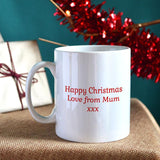The back of a personalised Christmas mug showing the custom message printed in red lettering