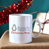 A personalised Christmas mug with a Penguin design and custom name