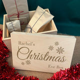 A personalised wooden Christmas Eve box filled with presents.