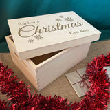 A personalised Christmas Eve box with an engraved design on the lid. The design features a name and 5 snowflakes.