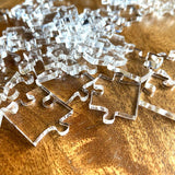 Clear jigsaw pieces part of an Impossible puzzle