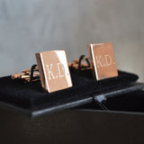 A close up of a pair of personalised rose gold cufflinks