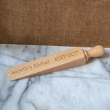 A personalised wooden door stop with an engraved message which reads "Isabella's Kitchen - KEEP OUT"