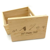 A personalised fishing tackle storage box made from natural wood with an engraved design on the lid.