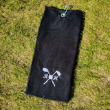 A personalised black golf towel with a metal clip for attaching to a bag