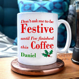 A personalised Christmas mug with the text "don't ask me to be festive until I've finished this coffee" printed on it