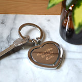 An engraved heart shaped metal keyring with a rotating centre.