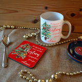 A personalised Christmas mug and matching coaster with the words "It's beginning to look a lot like Christmas, Aimee" printed on them next to an illustration of a Christmas tree