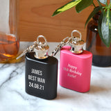 Personalised mini hip flasks engraved with messages in pink and black.
