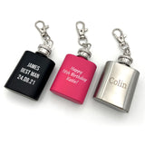Three keyring hip flasks in pink, silver and black all engraved with a custom message.