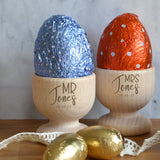 Personalised Mr and Mrs wooden egg cups, the set of two egg cups are engraved with titles and a surname.