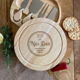 A personalised round wooden cheese board and knife set with the words No.1 Dad engraved on the top.
