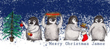 A personalised penguin Christmas mug with the message "Merry Christmas James"