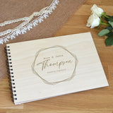 A personalised wedding guest book with an engraved plywood cover.  The book has names of your choice engraved on the font inside a hexagon pattern.