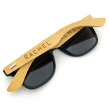 Personalised bamboo and wheat straw sunglasses with a custom name engraved on the arm.