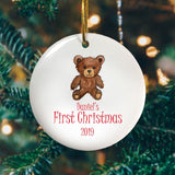 A personalised round Christmas tree decoration with a teddy bear printed on it