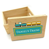 A personalised wooden toy train storage box with a blue and yellow train on it.