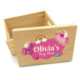 A personalised wooden toy box with pink unicorns printed on the lid. The toy box has space for a name of your choice in white lettering.
