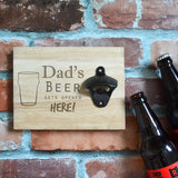 A personalised wooden sign with a wall mounted bottle opener attached. The sign has an engraved design with a message reading "Dad's beer goes here". Add any name in place off "Dad". 