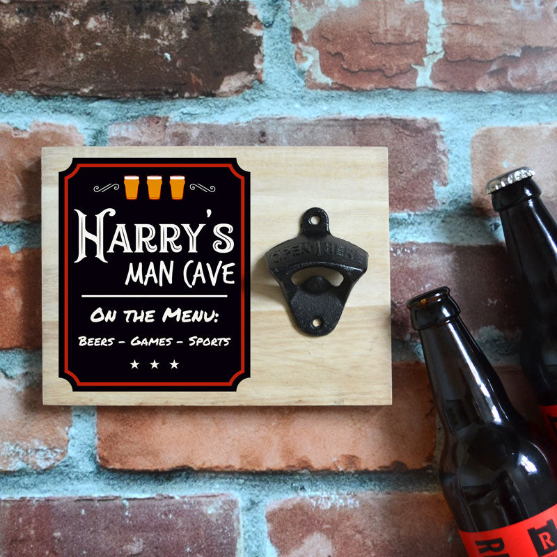 A personalised wooden Man Cave sign in the style of a pub chalk board. The sign has a wall mounted bottle opener attached.