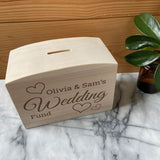 A personalised wedding fund money box on a table