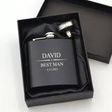 Personalised 6oz black hip flask featuring a design ideal for formal occasions such as weddings. Pictured inside a giftbox with a funnel. The message 'David - Best Man' and a date is engraved on the front.