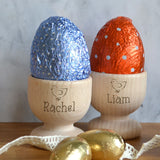 Two personalised wooden egg cups with a name and Easter chick engraved on the front