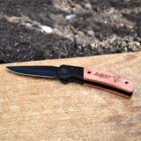 A personalised fishing knife with an engraved handle