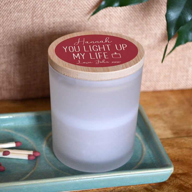 A personalised glass jar candle with a Valentine's Day design printed on the lid. 