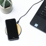 Round phone charger plugged into laptop